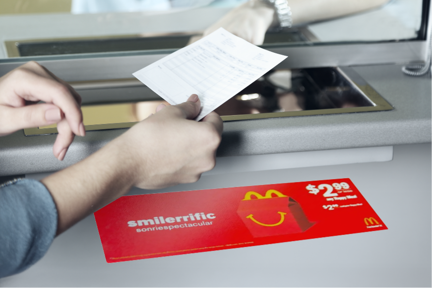 Customer receiving branded marketing materials at checkout counter